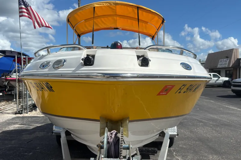 Slide: The Image of 2004 Chaparral 210 SSi boat with yellow hull and canopy, parked on trailer. - 7