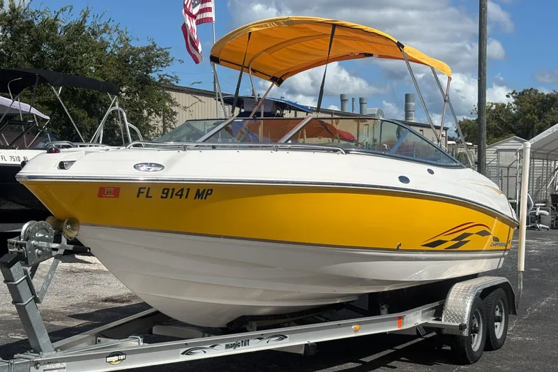 Slide: The Image of 2004 Chaparral 210 SSi boat with yellow hull and canopy on a trailer. - 8