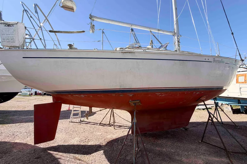 The Image of 1983 Hinterhoeller Niagara 35 sailboat on stands, showcasing hull and keel design. - 0