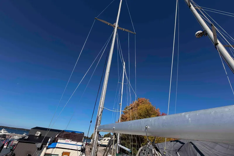 Slide: The Image of Mast of 1983 Hinterhoeller Niagara 35 sailboat against clear blue sky. - 11