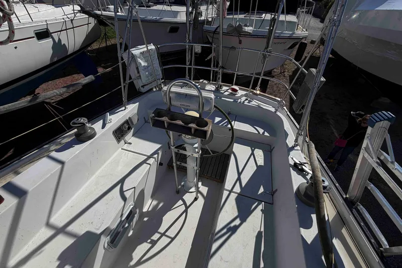 Slide: The Image of 1983 Hinterhoeller Niagara 35 sailboat cockpit with steering wheel and deck equipment. - 12