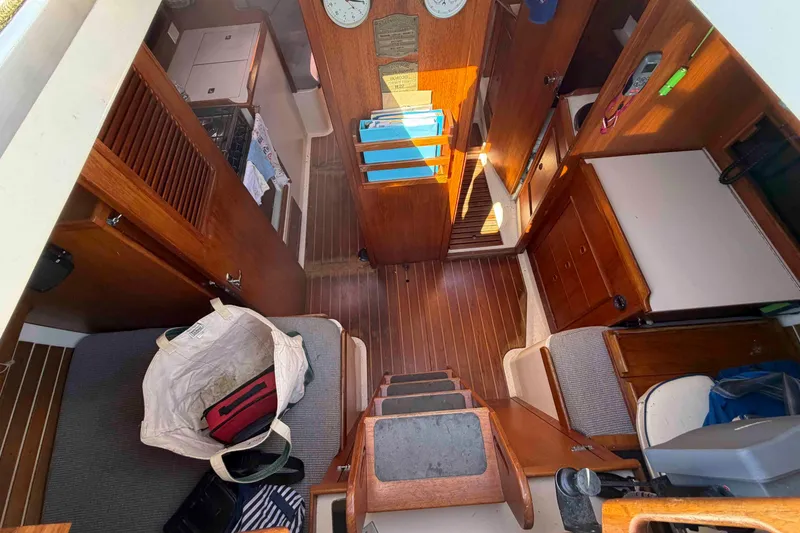 Slide: The Image of Interior of 1983 Hinterhoeller Niagara 35 sailboat with wooden finishes and cozy layout. - 16