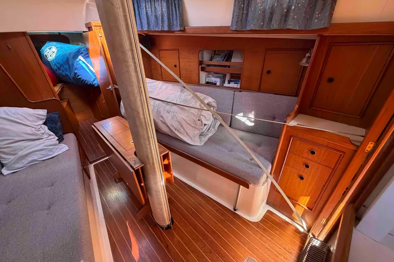 Slide: The Image of Interior of 1983 Hinterhoeller Niagara 35 sailboat with wooden cabinetry and cozy seating. - 19