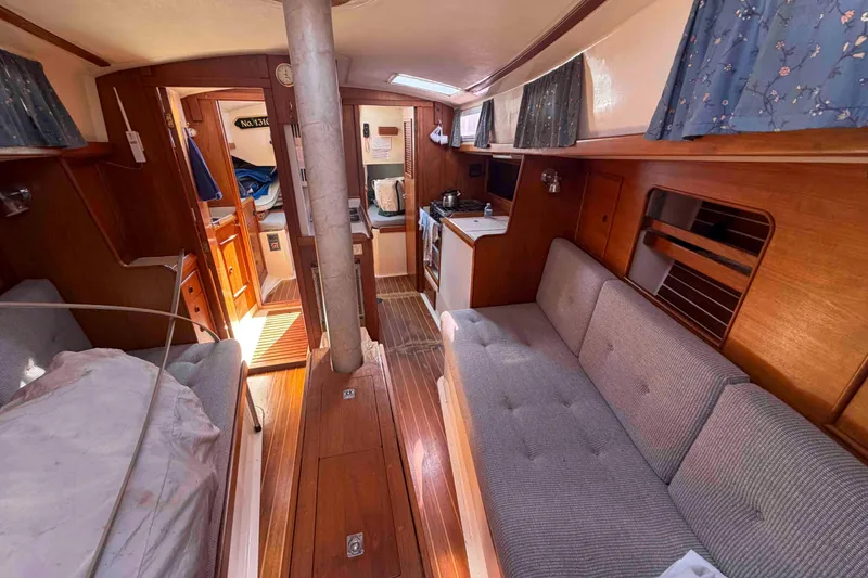 Slide: The Image of Interior of 1983 Hinterhoeller Niagara 35 sailboat with cozy seating and wooden finishes. - 20