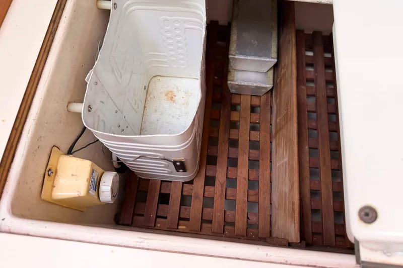 Slide: The Image of Storage compartment of 1983 Hinterhoeller Niagara 35 sailboat with wooden slats and equipment. - 25