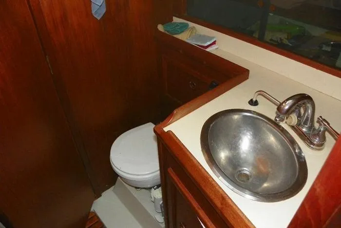 Slide: The Image of 1983 Hinterhoeller Niagara 35 yacht bathroom with sink and toilet. - 28