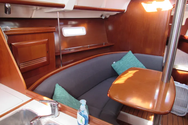 Slide: The Image of Interior of 2005 Beneteau Oceanis 373 sailboat with wooden finish and cozy seating area. - 10
