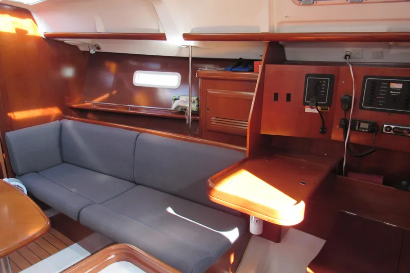 Slide: The Image of Interior of 2005 Beneteau Oceanis 373 sailboat with wooden finish and seating area. - 11