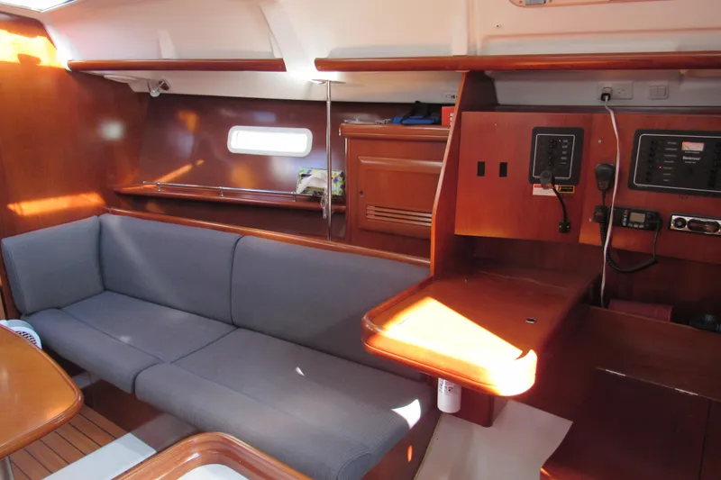 Slide: The Image of 2005 Beneteau Oceanis 373 interior with wooden finish and comfortable seating. - 12