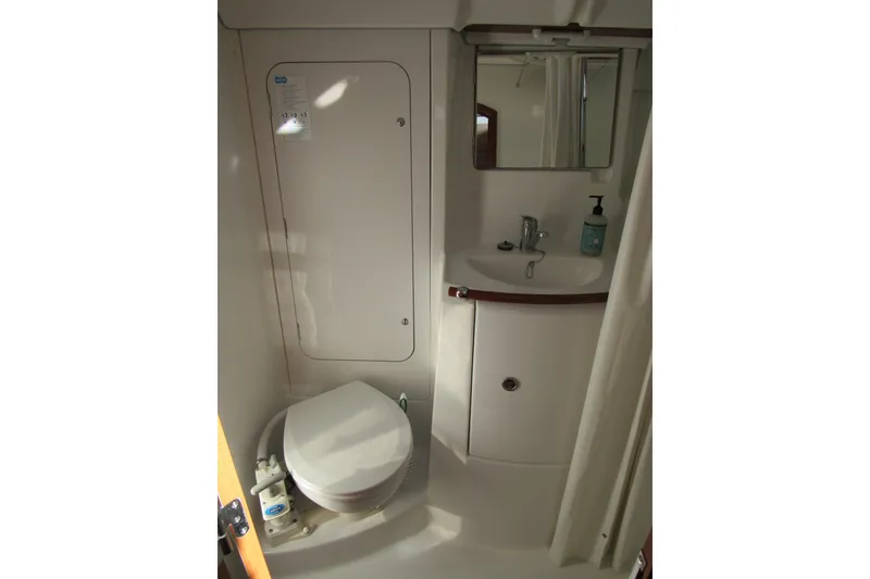 Slide: The Image of Compact bathroom in 2005 Beneteau Oceanis 373 sailboat with toilet, sink, and mirror. - 14