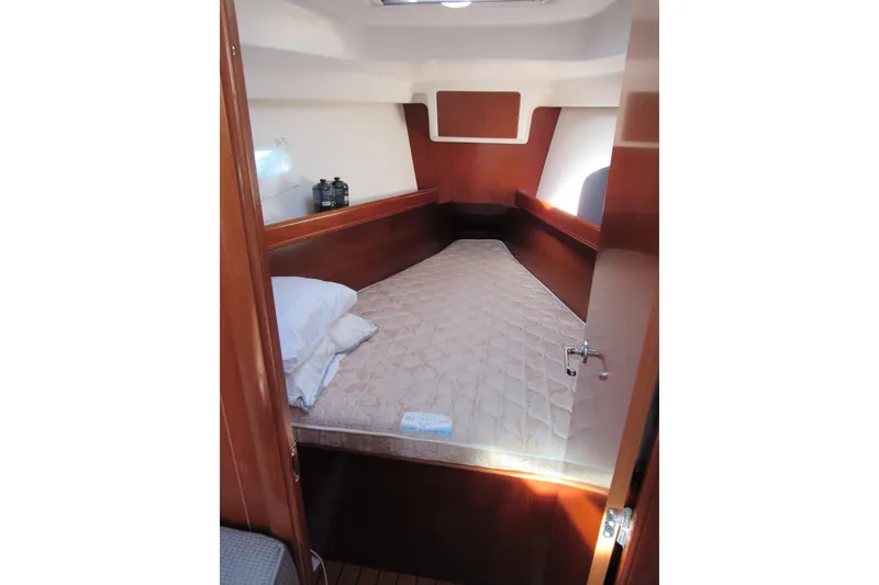 Slide: The Image of 2005 Beneteau Oceanis 373 cabin interior with bed and wooden finish. - 15