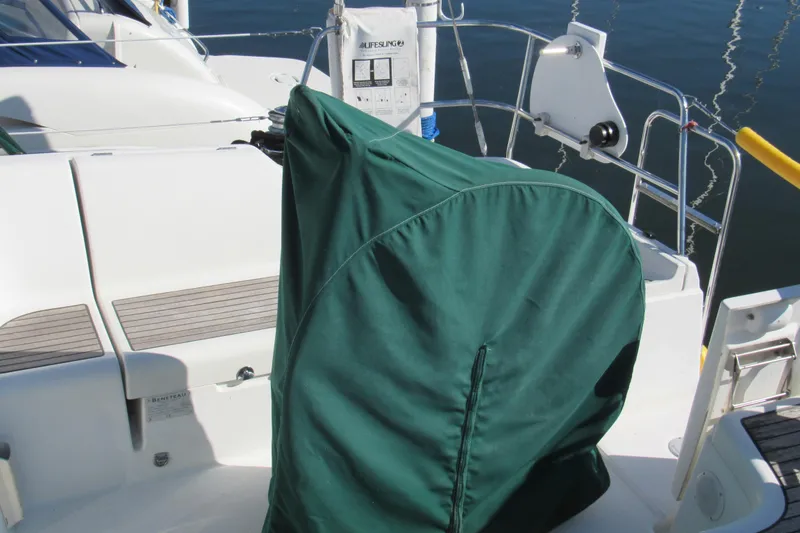 Slide: The Image of 2005 Beneteau Oceanis 373 sailboat cockpit with green cover and seating area. - 4