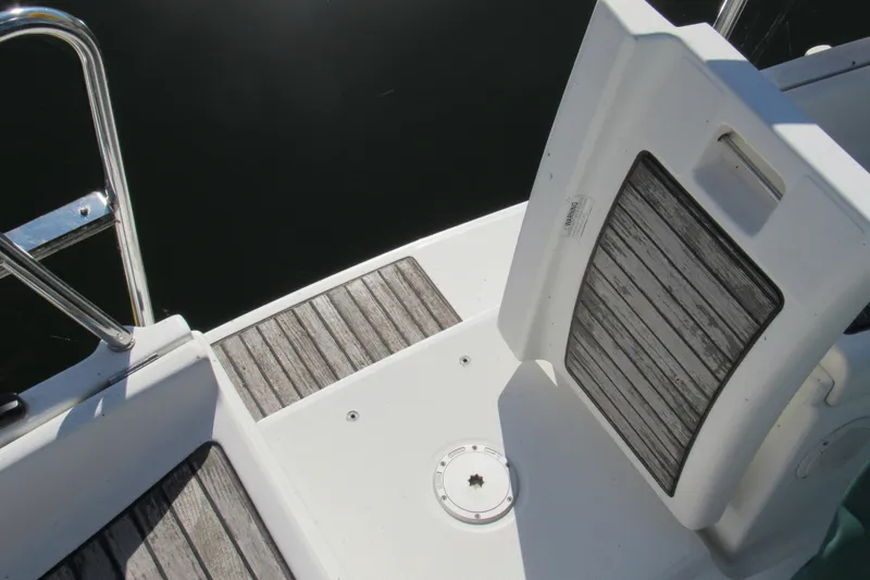 Slide: The Image of 2005 Beneteau Oceanis 373 yacht deck with wooden panels and stainless steel railing. - 7