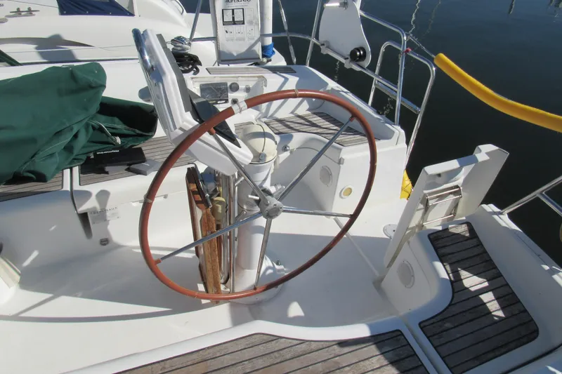Slide: The Image of Steering wheel of a 2005 Beneteau Oceanis 373 sailboat, docked at a marina. - 9