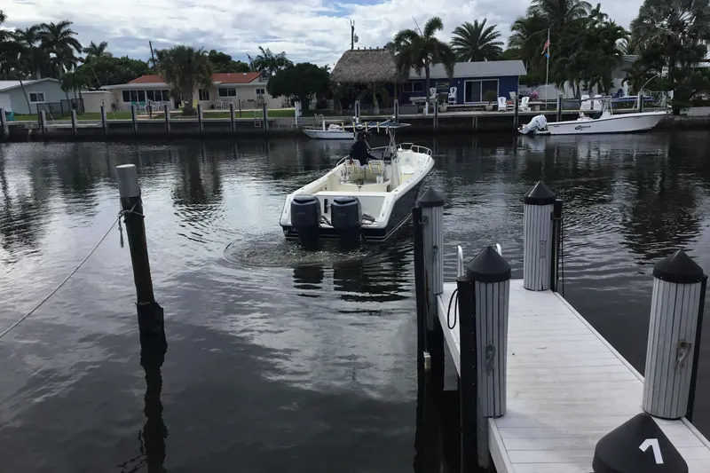 Slide: The Image of 2007 Pursuit C 280 Center Console boat docked in a calm marina setting. - 11