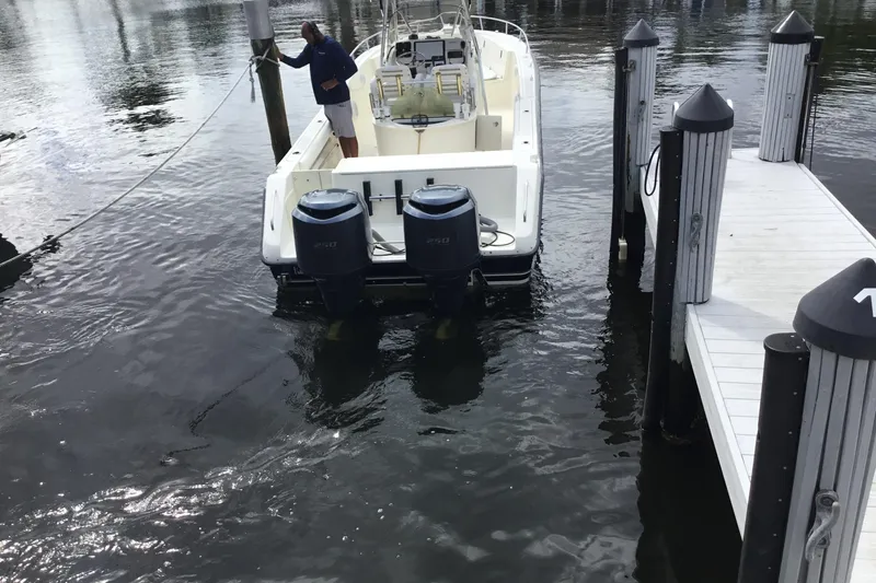 Slide: The Image of 2007 Pursuit C 280 Center Console boat docked with dual outboard engines. - 12
