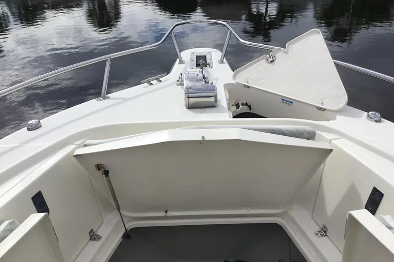 Slide: The Image of 2007 Pursuit C 280 Center Console boat deck with open storage compartments. - 14