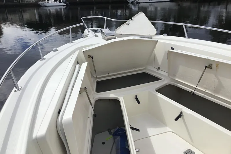 Slide: The Image of 2007 Pursuit C 280 Center Console boat with open storage compartments on calm water. - 15