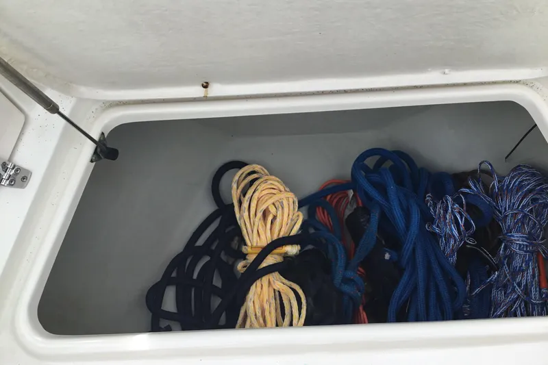 Slide: The Image of Storage compartment with ropes on a 2007 Pursuit C 280 Center Console boat. - 16