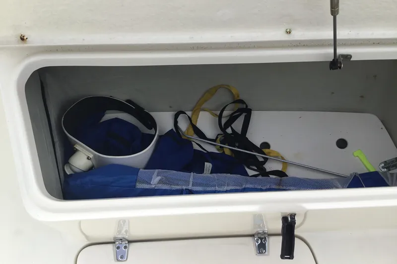 Slide: The Image of Storage compartment of 2007 Pursuit C 280 Center Console with boating gear. - 17