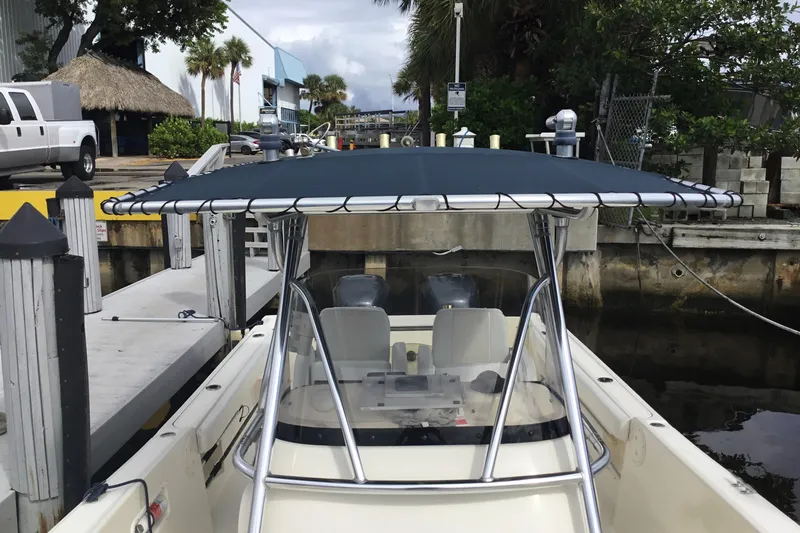 Slide: The Image of 2007 Pursuit C 280 Center Console boat docked at marina with canopy. - 21