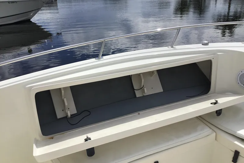 Slide: The Image of 2007 Pursuit C 280 Center Console boat with open storage compartment on calm water. - 23