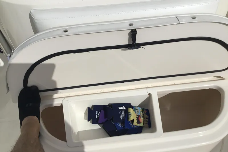 Slide: The Image of Storage compartment on a 2007 Pursuit C 280 Center Console boat, containing beverage holders. - 25