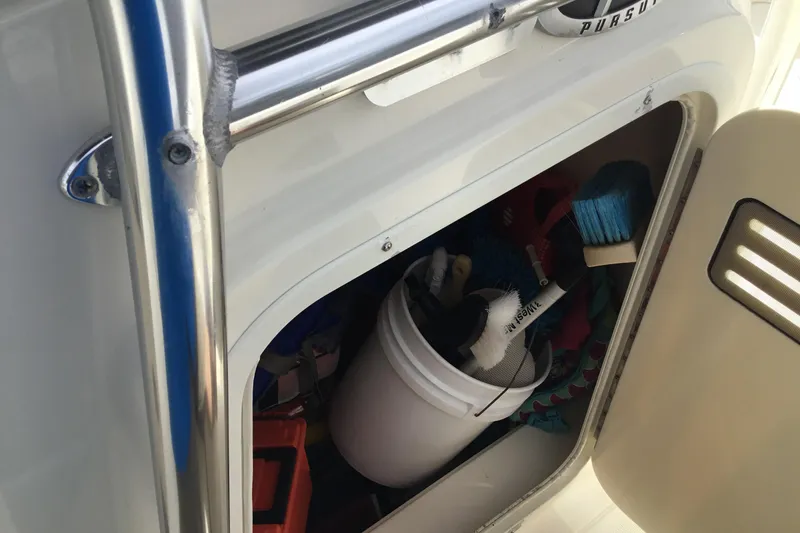 Slide: The Image of Storage compartment on 2007 Pursuit C 280 Center Console with cleaning supplies. - 28