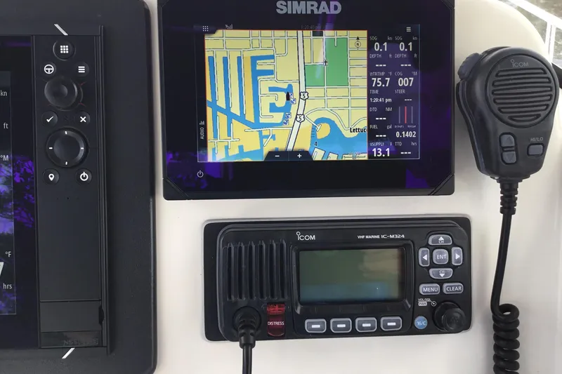Slide: The Image of Simrad navigation system and Icom VHF radio on 2007 Pursuit C 280 Center Console. - 33