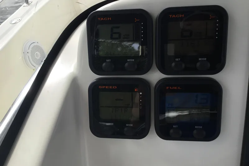 Slide: The Image of 2007 Pursuit C 280 Center Console dashboard with tachometer, speed, and fuel gauges. - 34