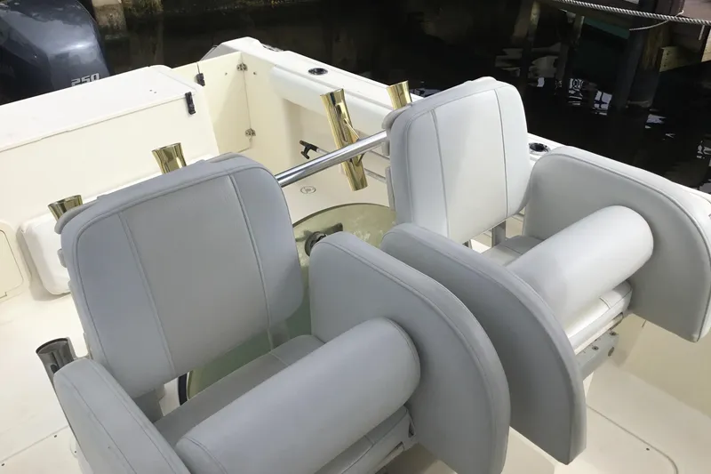 Slide: The Image of 2007 Pursuit C 280 Center Console boat with white cushioned seating. - 35