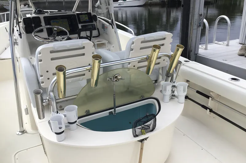 Slide: The Image of 2007 Pursuit C 280 Center Console boat interior with fishing rod holders and control panel. - 37