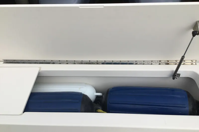 Slide: The Image of Open storage compartment on 2007 Pursuit C 280 Center Console boat. - 38