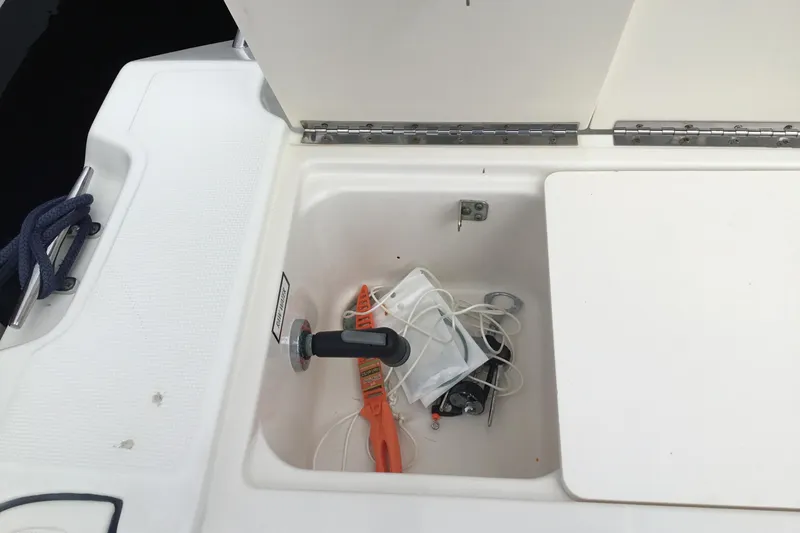 Slide: The Image of 2007 Pursuit C 280 Center Console storage compartment with tools and accessories. - 39