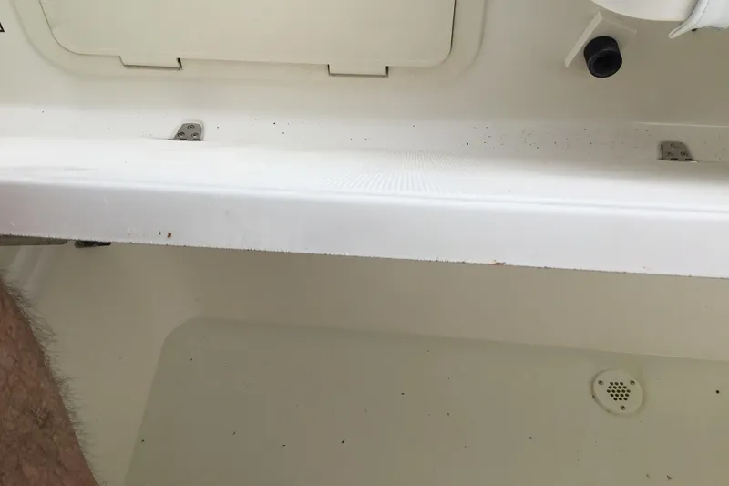 Slide: The Image of 2007 Pursuit C 280 Center Console interior detail, showing storage compartment and drainage. - 43