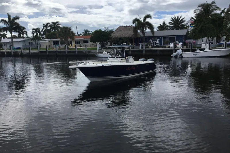 Slide: The Image of 2007 Pursuit C 280 Center Console boat on calm water near waterfront homes. - 7