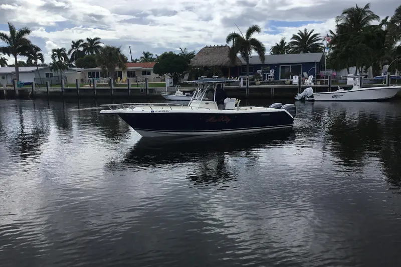 Slide: The Image of 2007 Pursuit C 280 Center Console boat docked near waterfront homes. - 8