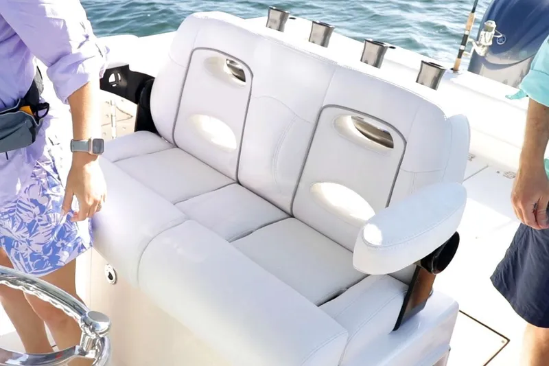 Slide: The Image of 2026 Sea Born LX26 Center Console boat with blue T-top and white seating. - 4