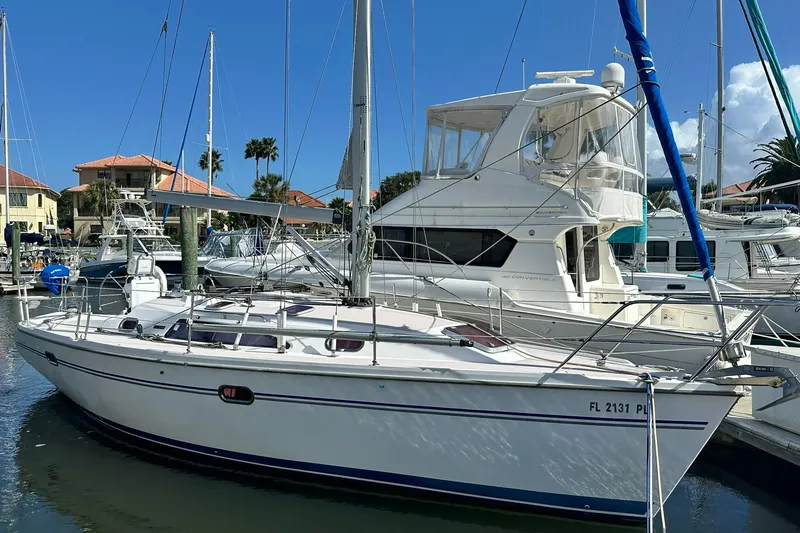 The Image of 2008 Catalina 320 sailboat docked in a marina under clear blue skies. - 1