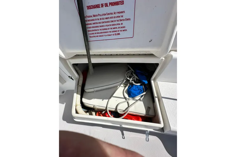 Slide: The Image of Open storage compartment on 2008 Catalina 320 boat with ropes and equipment. - 13