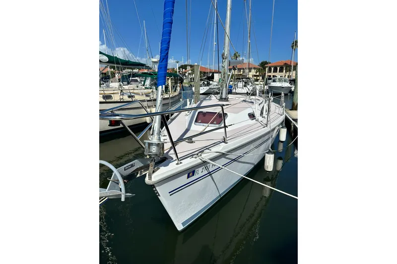 Slide: The Image of 2008 Catalina 320 sailboat docked in marina under clear blue sky. - 18