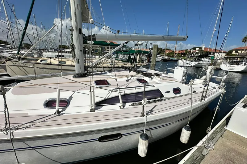 Slide: The Image of Catalina 320 sailboat from 2008 docked in a marina under clear blue skies. - 20