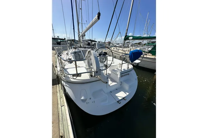 Slide: The Image of 2008 Catalina 320 sailboat docked at marina, featuring sleek design and spacious deck. - 21