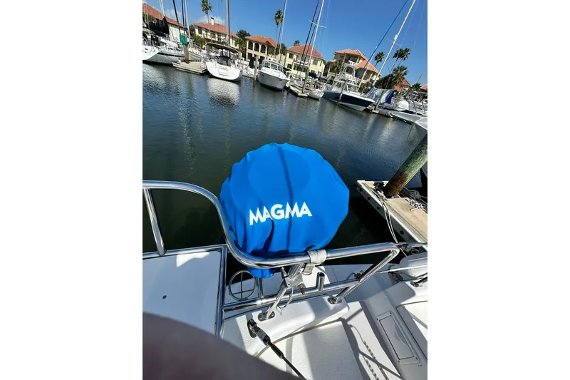 Slide: The Image of Catalina 320 sailboat at marina, featuring Magma grill cover, 2008 model. - 29