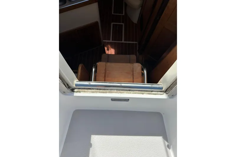 Slide: The Image of Interior view of a 2008 Catalina 320 sailboat, showing wooden flooring and seating. - 33