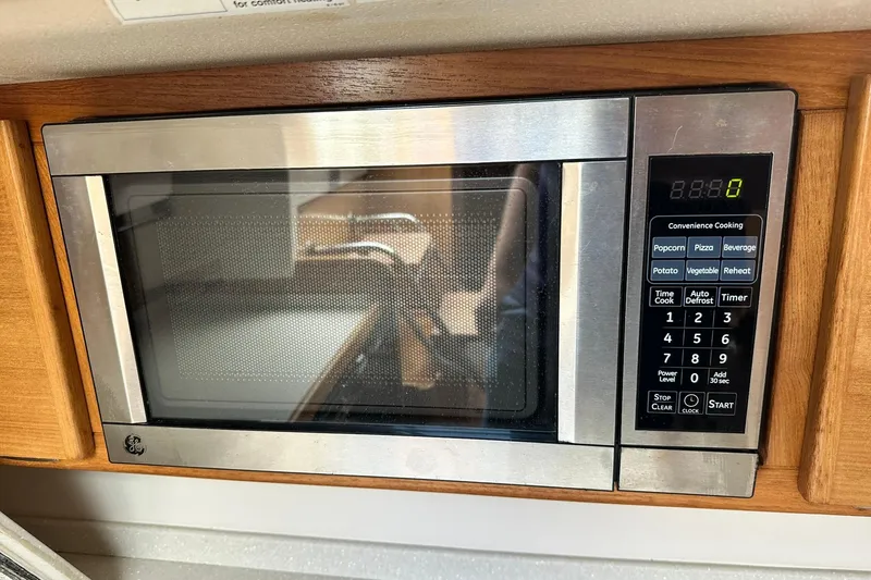 Slide: The Image of Built-in microwave in a 2008 Catalina 320, featuring digital controls and wood paneling. - 36