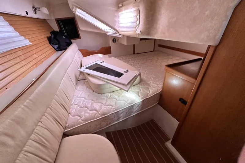 Slide: The Image of Interior cabin of a 2008 Catalina 320 sailboat with cozy seating and bedding. - 37