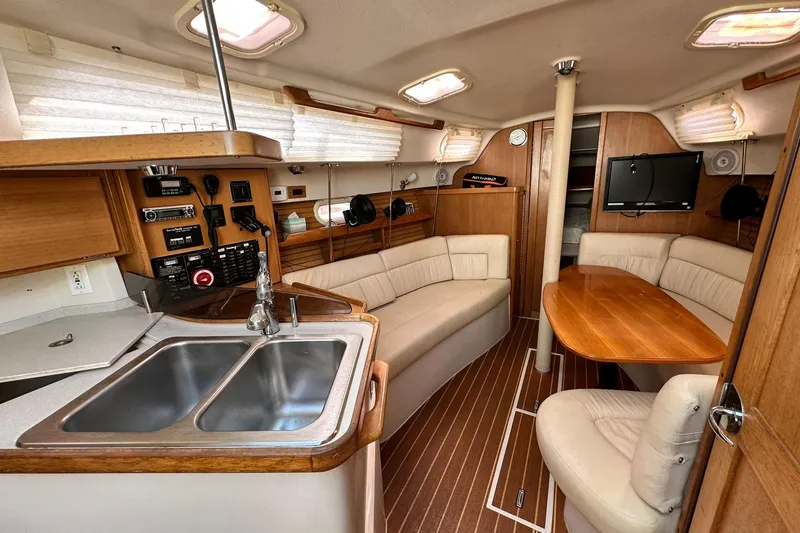 Slide: The Image of Luxurious interior of a 2008 Catalina 320 sailboat with modern amenities and cozy seating. - 43