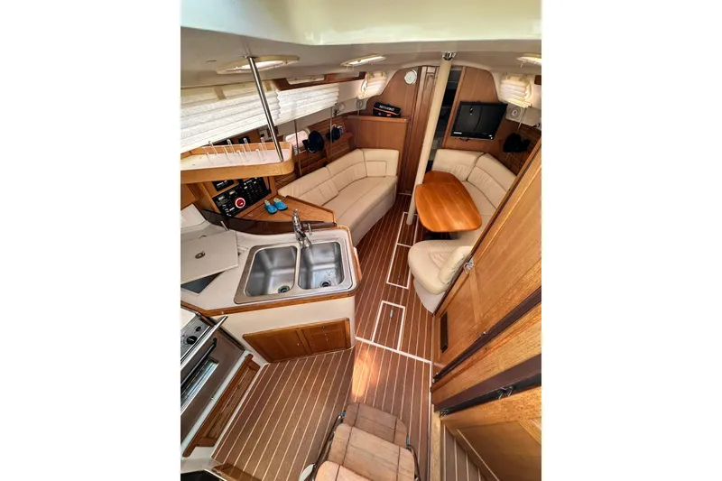 Slide: The Image of Interior of 2008 Catalina 320 yacht with cozy seating, wooden flooring, and compact kitchen. - 46