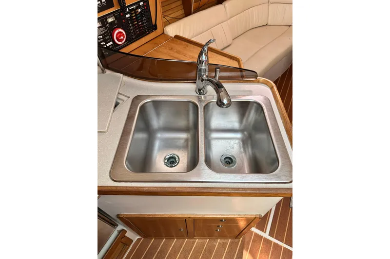 Slide: The Image of 2008 Catalina 320 yacht kitchen with dual stainless steel sinks and modern faucet. - 48